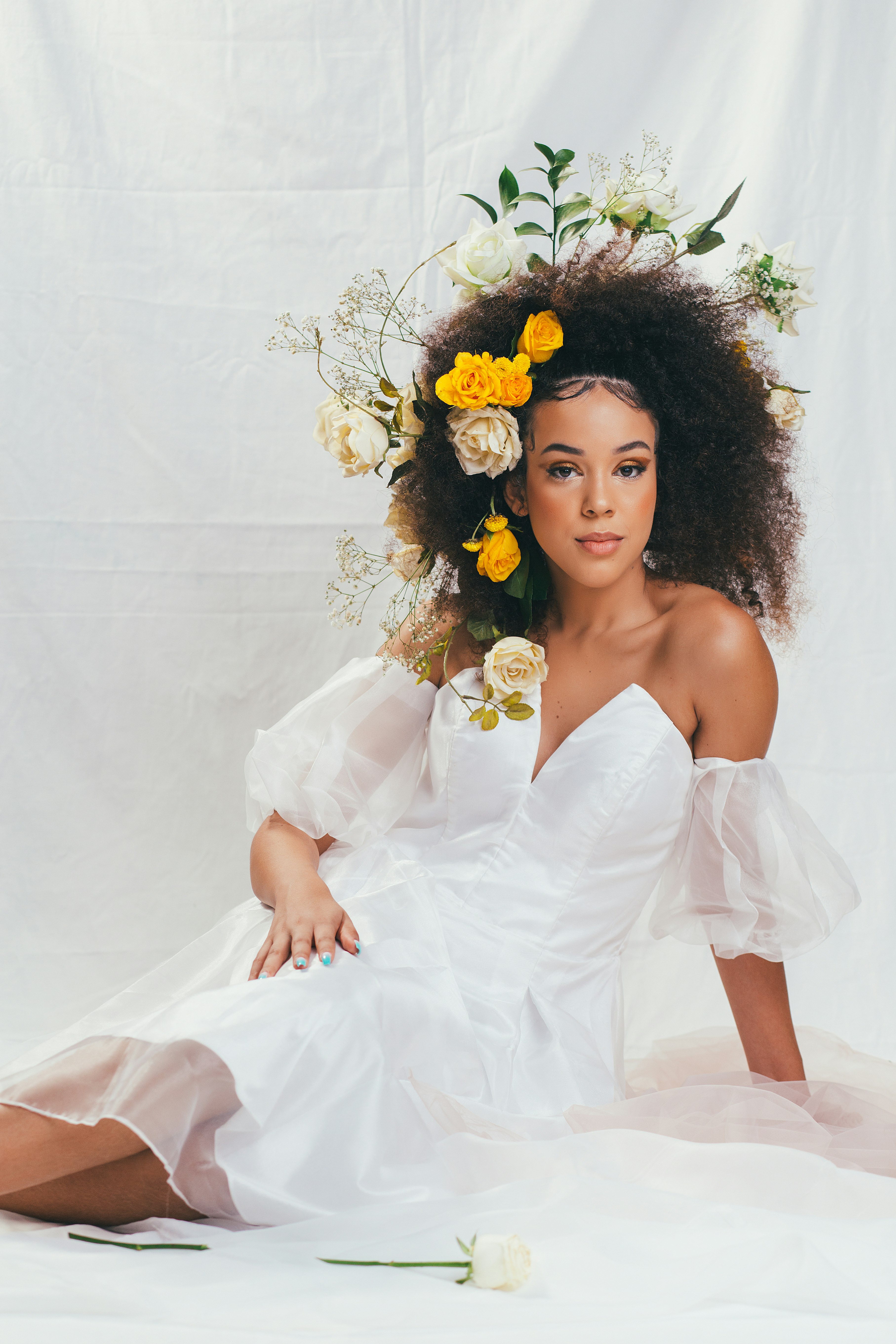 woman in white tube dress with yellow flower on head